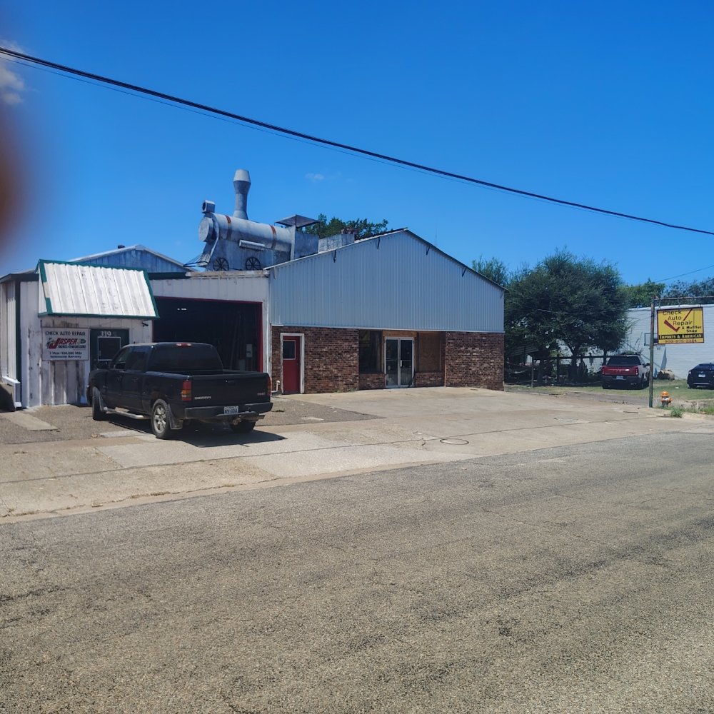 Check Auto Repair storefront at 319 N Prairieville St in Athens, TX, with the yellow Check Auto Repair sign out front